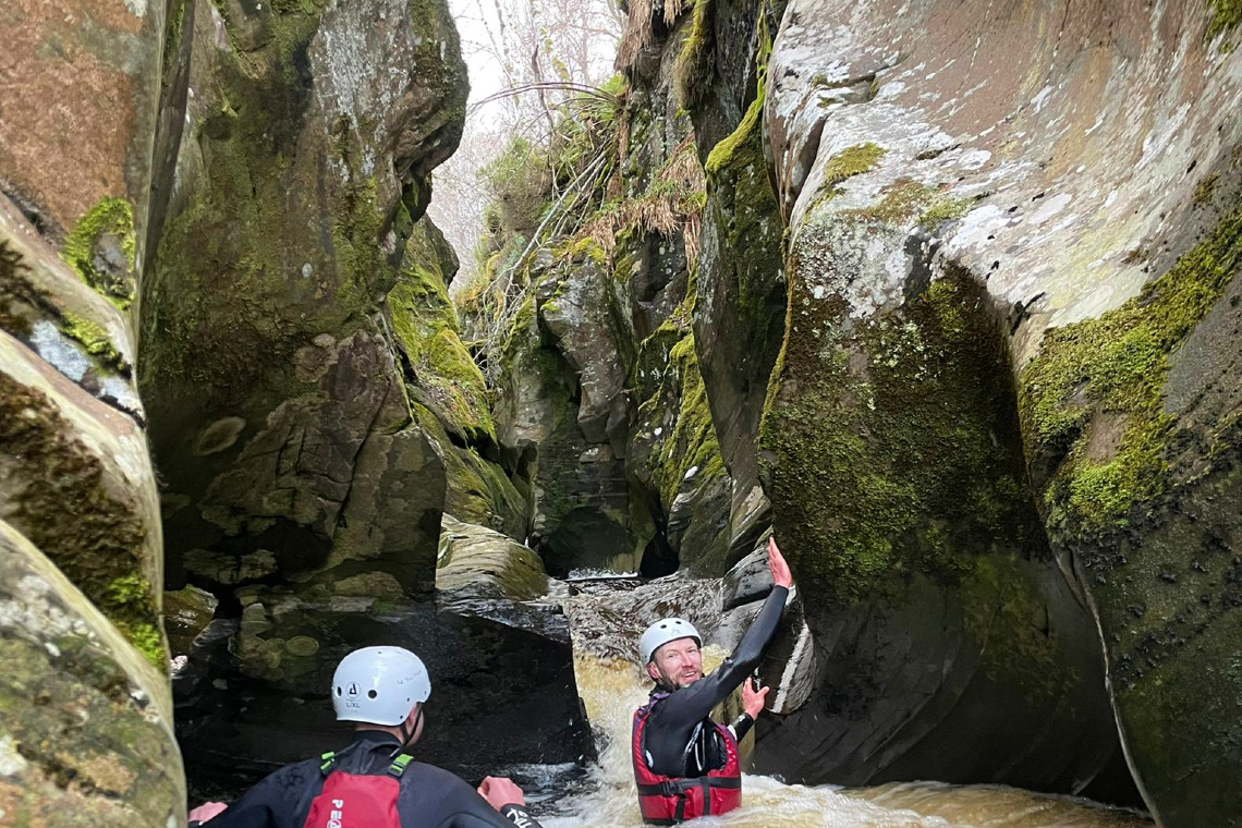 People in a deep gorge during a gorge walking activity session
