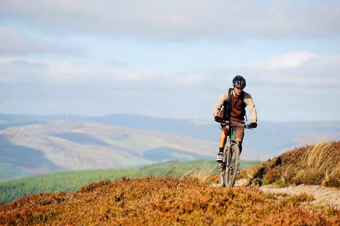 a mountain biker on a remote hill track