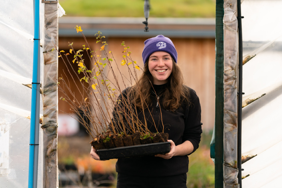 trees for life staff at dundreggan tree nursery holding a young seedling