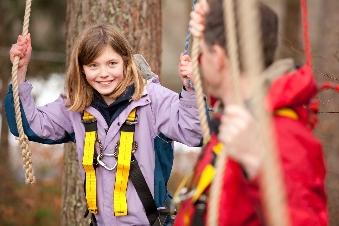young person smiling while at treezone treetop adventure course