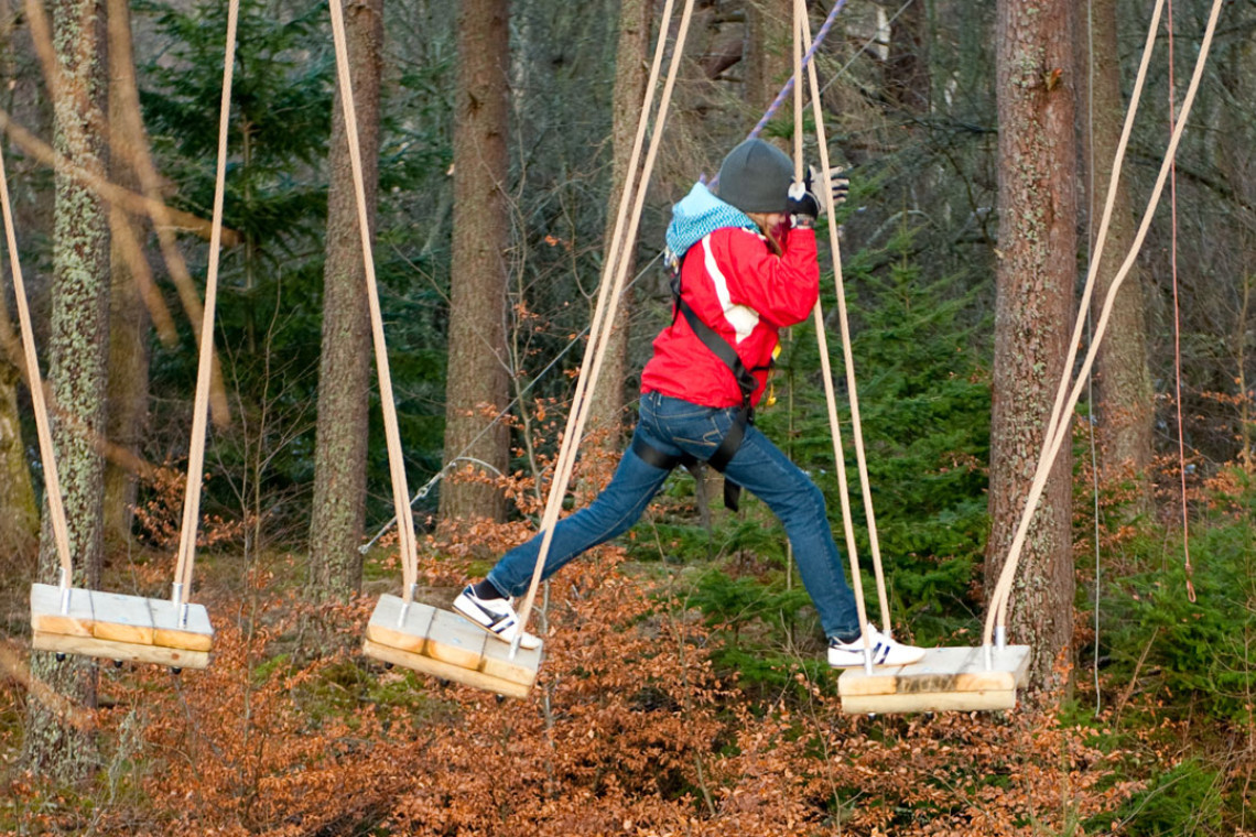 young person on wobbly rope crossing while at treezone treetop adventure course